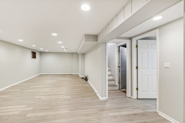 basement with light hardwood / wood-style flooring