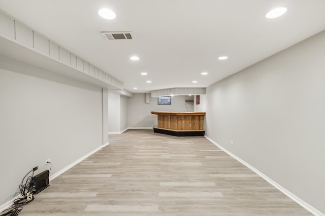 bar featuring light hardwood / wood-style floors