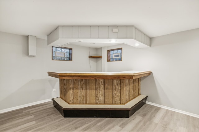 bar with light hardwood / wood-style floors