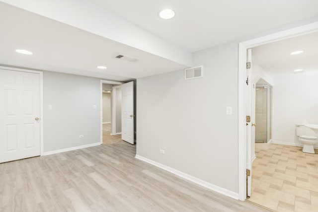 basement with light hardwood / wood-style floors