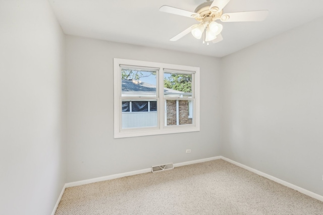 carpeted spare room with ceiling fan