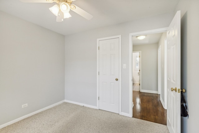 carpeted empty room with ceiling fan