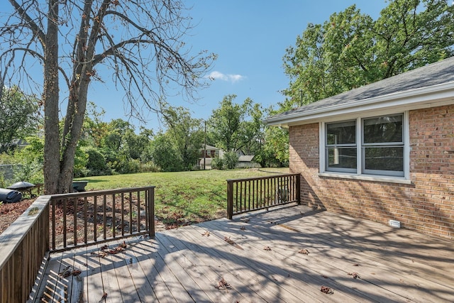 wooden terrace featuring a yard