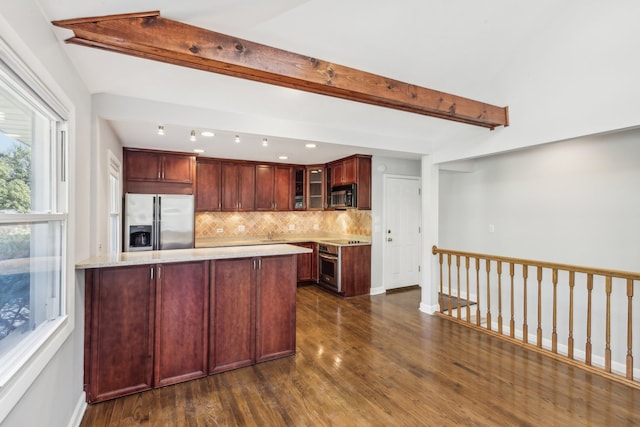 kitchen with light stone countertops, appliances with stainless steel finishes, dark hardwood / wood-style flooring, beamed ceiling, and decorative backsplash