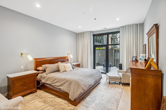 bedroom with light wood-type flooring, recessed lighting, and access to exterior