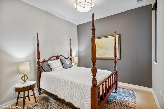 bedroom featuring baseboards and wood finished floors