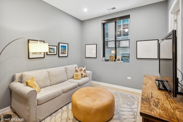 living area with baseboards and recessed lighting