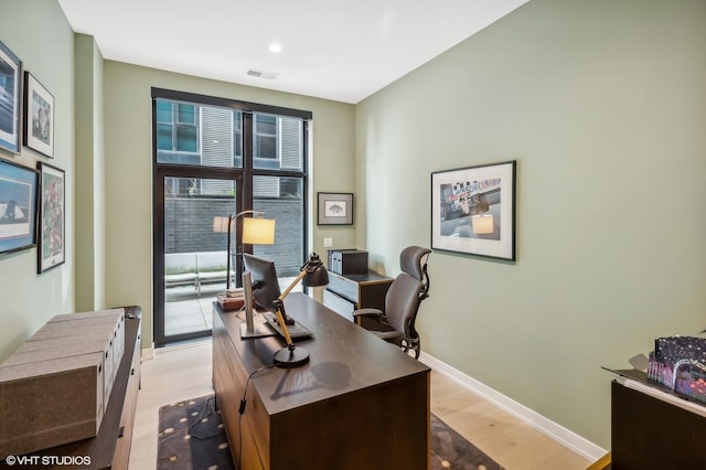 office featuring light wood-type flooring, baseboards, and recessed lighting