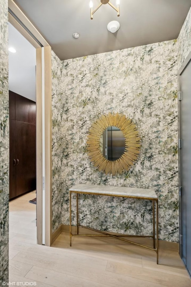 detailed view of wallpapered walls and wood finished floors