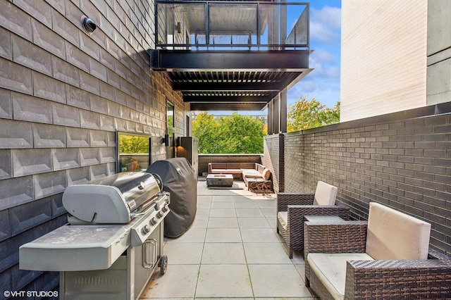 view of patio featuring a fire pit, a balcony, and area for grilling