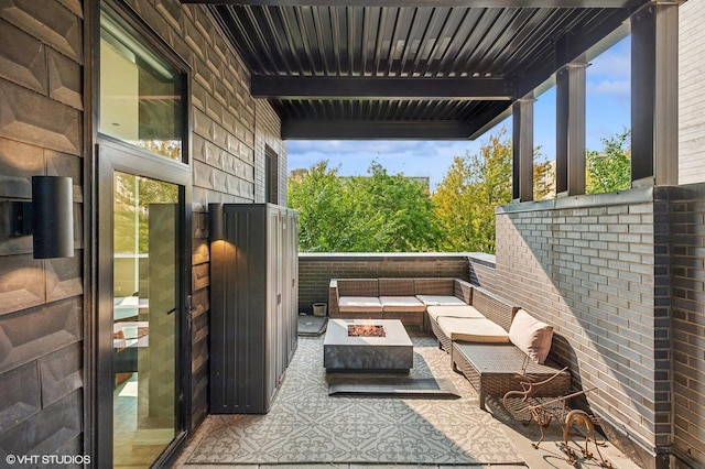 view of patio featuring an outdoor living space with a fire pit