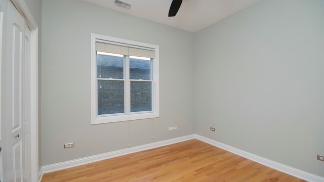 empty room featuring ceiling fan and hardwood / wood-style floors