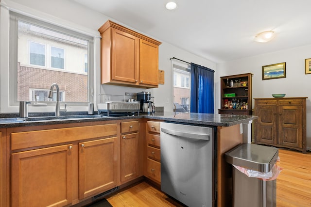 kitchen featuring dishwasher, light hardwood / wood-style floors, kitchen peninsula, and sink