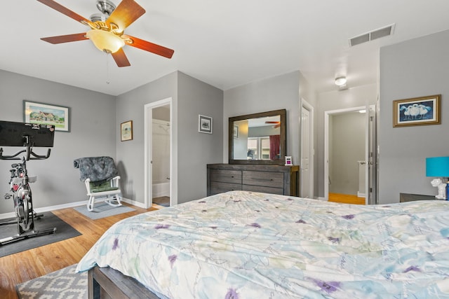 bedroom featuring a closet, light hardwood / wood-style floors, ensuite bath, and ceiling fan