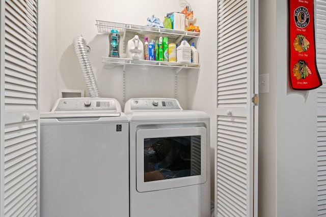 clothes washing area featuring washer and clothes dryer