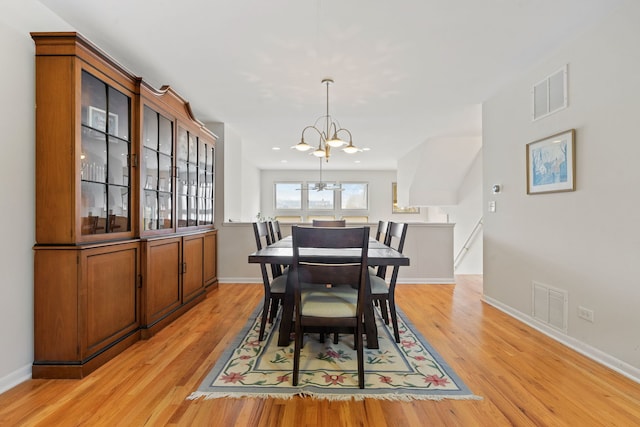 dining room featuring light hardwood / wood-style floors and an inviting chandelier