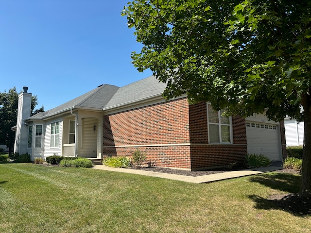 view of side of home featuring a yard and a garage