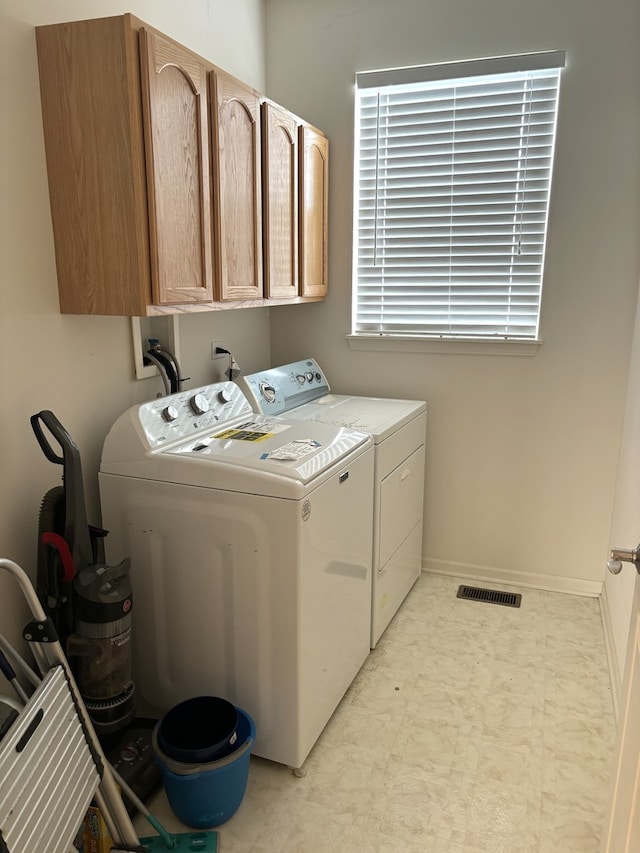 laundry area with cabinets and washer and dryer