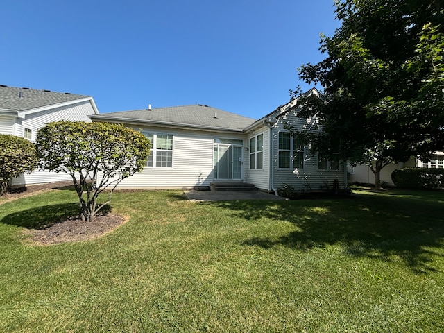 rear view of house with a yard