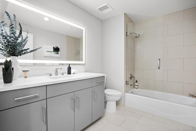 full bath with shower / bath combination, visible vents, toilet, vanity, and tile patterned floors