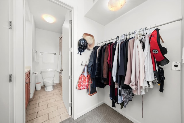 spacious closet with light tile patterned flooring