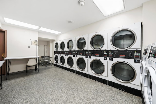 clothes washing area featuring stacked washer and clothes dryer and separate washer and dryer