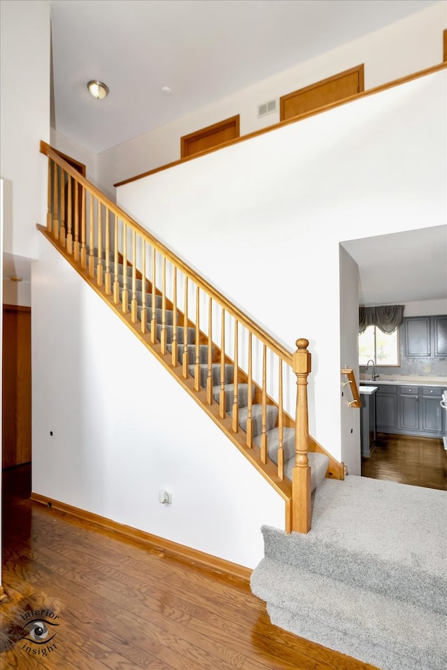 staircase with wood-type flooring