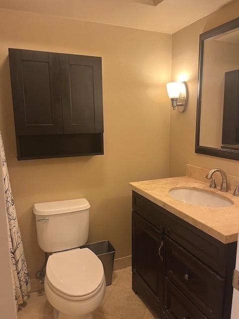 bathroom featuring vanity, toilet, and tile patterned floors