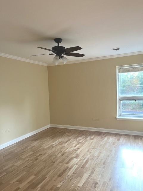 unfurnished room with ceiling fan, hardwood / wood-style flooring, and crown molding