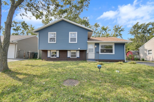 split level home featuring a garage and a front lawn