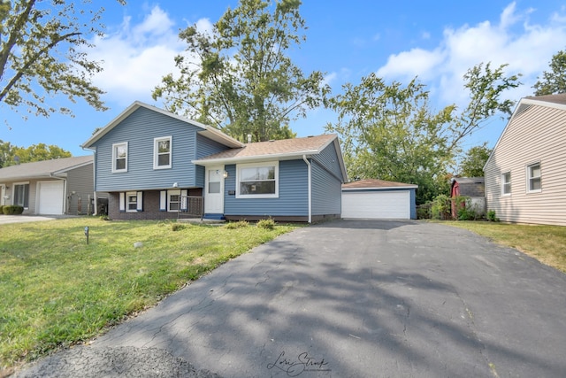 split level home with a garage, an outdoor structure, and a front yard