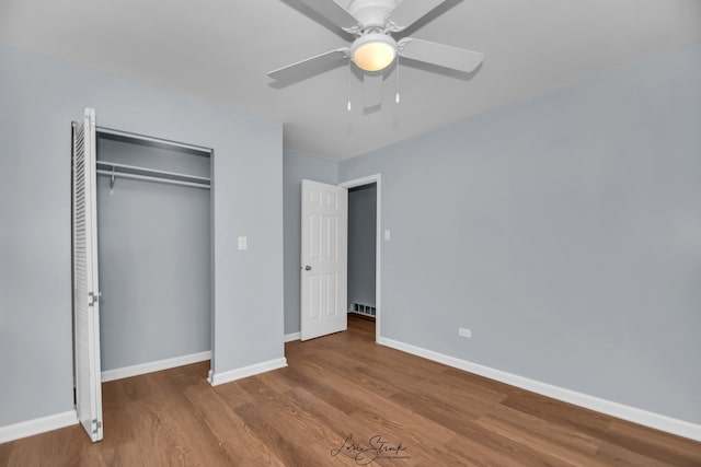 unfurnished bedroom with a closet, ceiling fan, and wood-type flooring