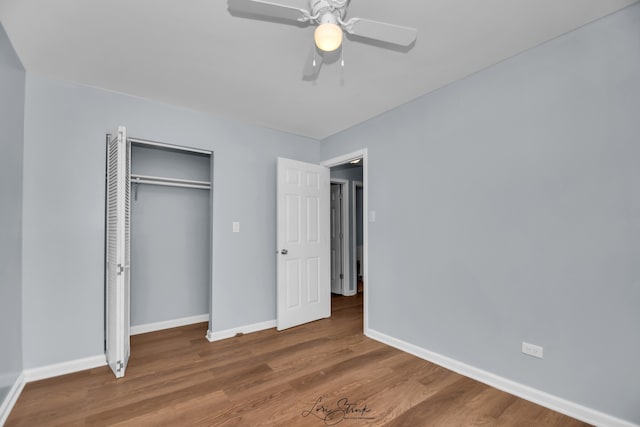 unfurnished bedroom featuring a closet, ceiling fan, and wood-type flooring