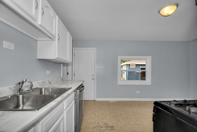 kitchen with stainless steel dishwasher, white cabinets, light tile patterned floors, and sink