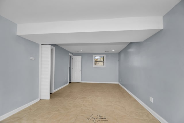 basement with light tile patterned flooring