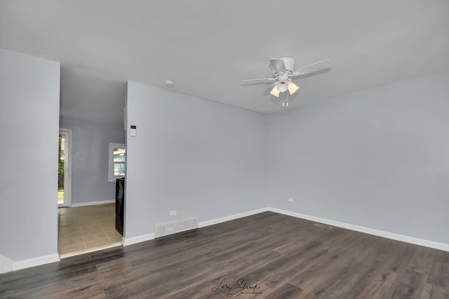 empty room with ceiling fan and dark hardwood / wood-style floors