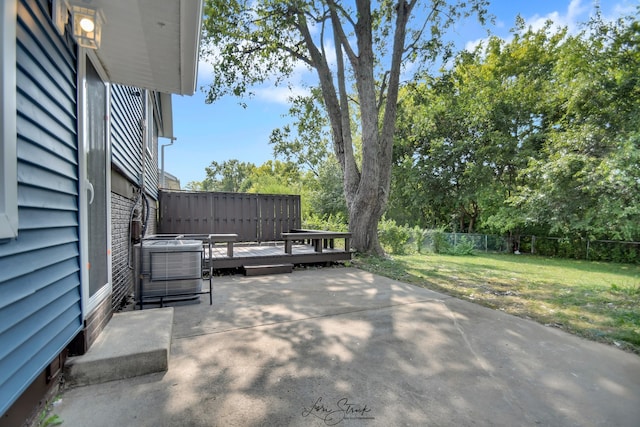 view of patio / terrace with a wooden deck and central air condition unit