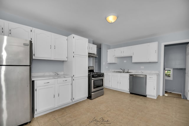 kitchen featuring stainless steel appliances, sink, and white cabinetry