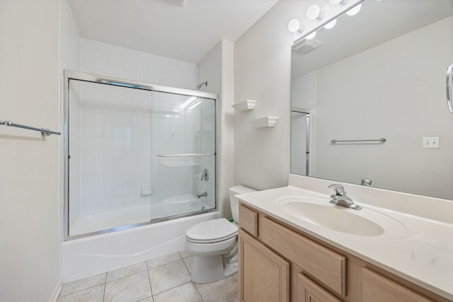 full bathroom with tile patterned flooring, combined bath / shower with glass door, vanity, and toilet