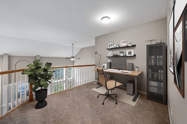 home office featuring vaulted ceiling, ceiling fan, and carpet flooring