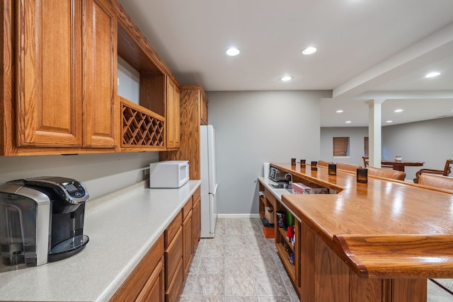 kitchen featuring ornate columns and white appliances