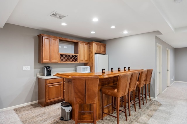 bar with light colored carpet and white appliances