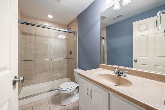 bathroom featuring vanity, a shower with shower door, toilet, and tile patterned flooring