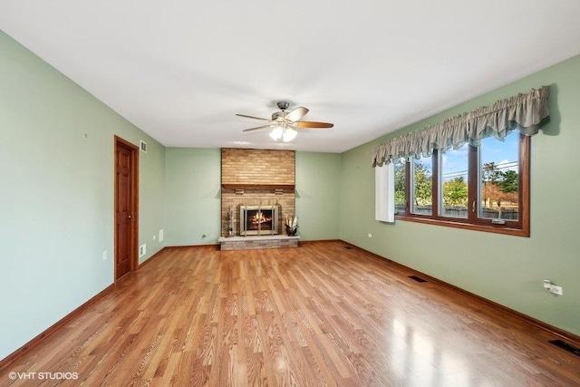 unfurnished living room with light wood-type flooring and ceiling fan