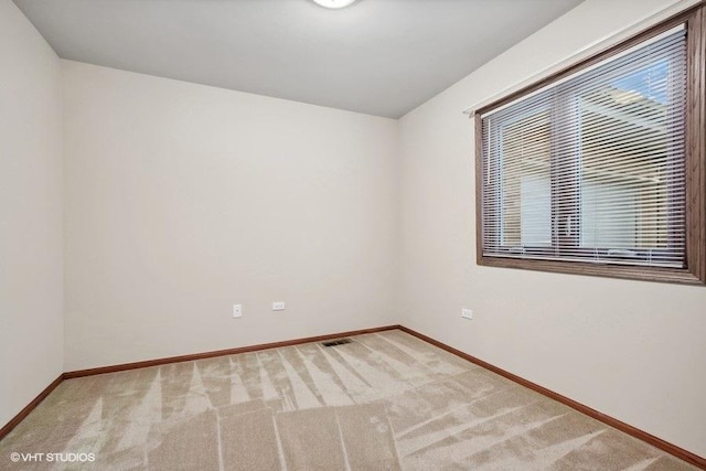 empty room featuring carpet, ceiling fan, and wooden walls