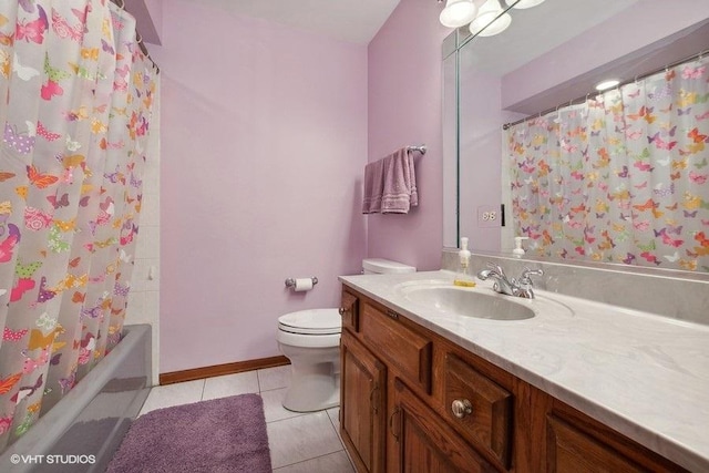 bathroom featuring tile patterned floors, vanity, toilet, and a shower with door