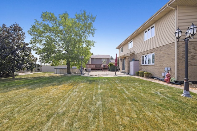 back of property with a yard and a patio