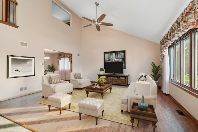 unfurnished living room featuring ceiling fan, wood-type flooring, and lofted ceiling