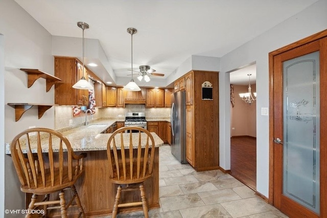 kitchen featuring ceiling fan, sink, hanging light fixtures, stainless steel appliances, and custom exhaust hood