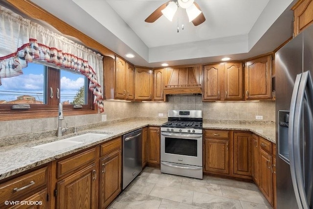 kitchen with kitchen peninsula, a brick fireplace, ceiling fan, decorative light fixtures, and light hardwood / wood-style flooring